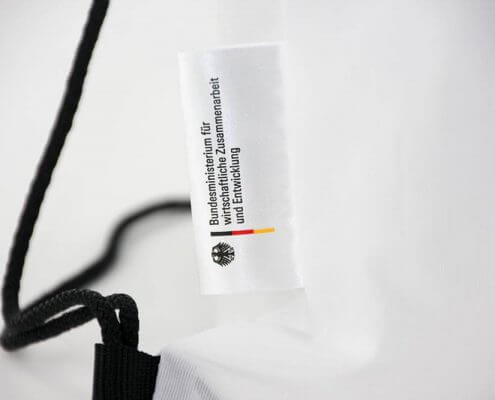Nennung des Kundennamens am Turnbeutel